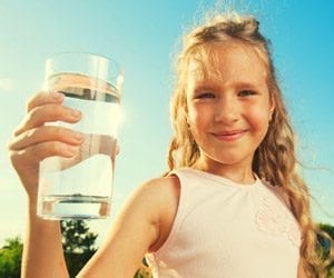 serious dentist talking to concerned patient about fluoride